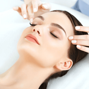 woman having a temple massage for Eighty-One Medical